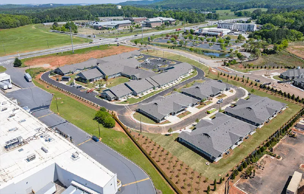 Aerial view of school campus with academic buildings, sports fields, and parking lots